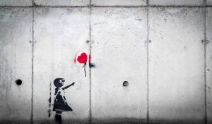 Photo of cement wall with graffiti art