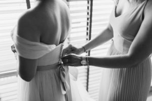 Woman Fixing Dress Of Woman
